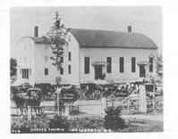 SA1410.21 - Many horses and buggies outside the New Lebanon, NY meeting house. Identified on the front., Winterthur Shaker Photograph and Post Card Collection 1851 to 1921c